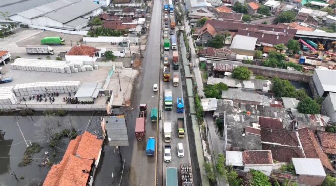 
					Arus lalu lintas di ruas tersebut terpantau lancar setelah pemasangan water barrier dan pengoperasian Mobile Pump Unit (MPU) untuk menyedot genangan air rob. (Foto: Zulkarnain)

